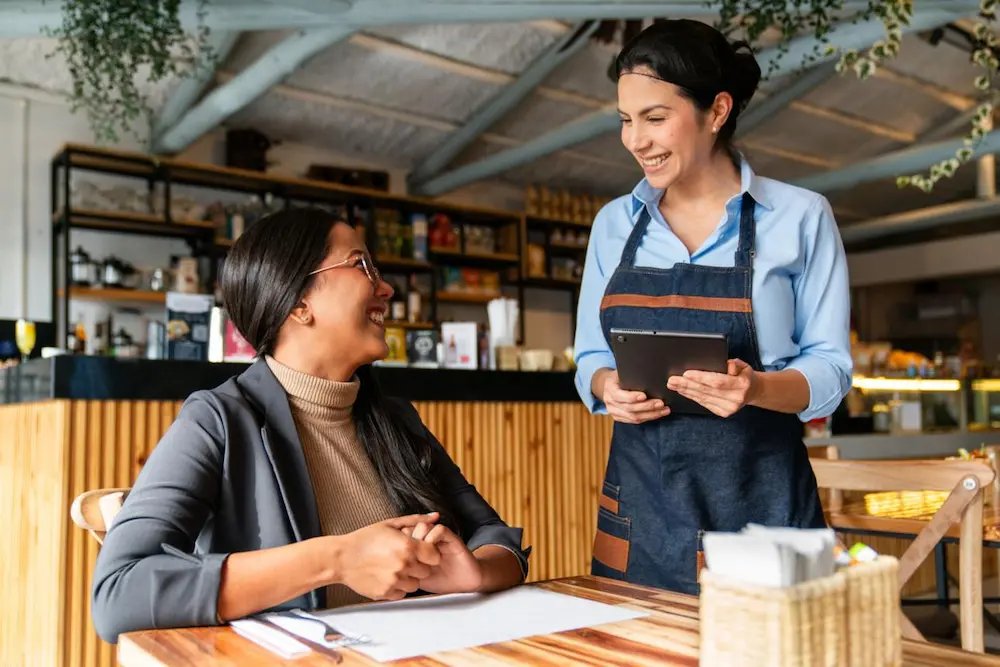 Restaurant staff listening to customer feedback and providing friendly service